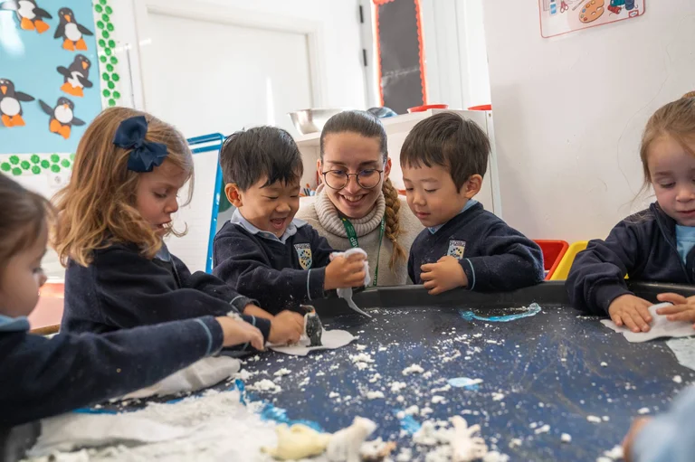 Teacher with two kids in the classroom