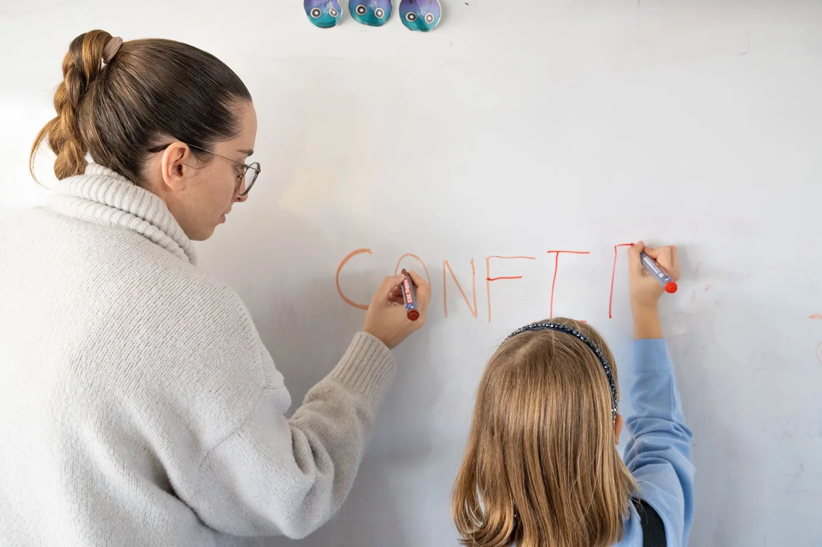Teacher and student writing