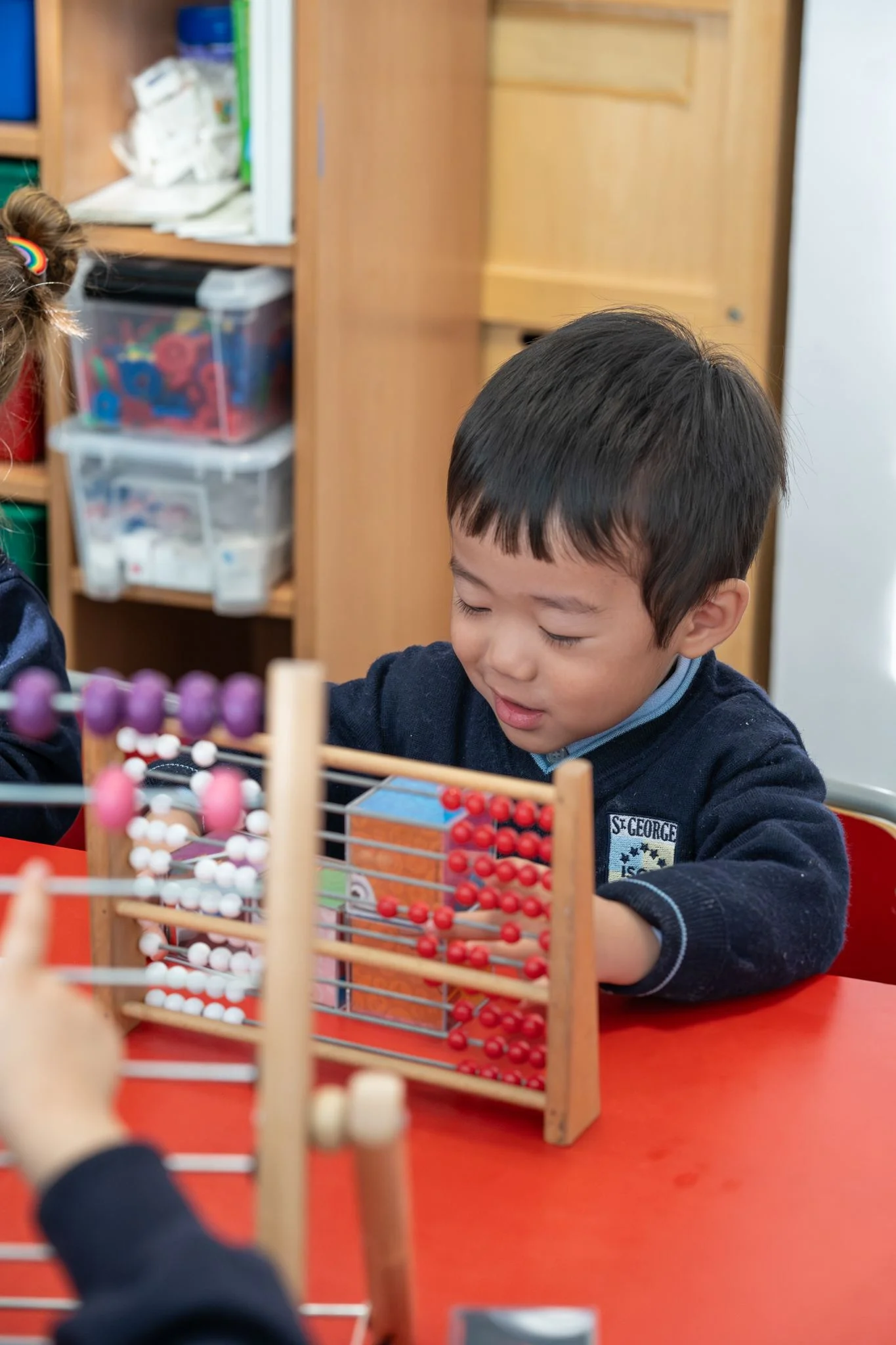 child plays with abacus