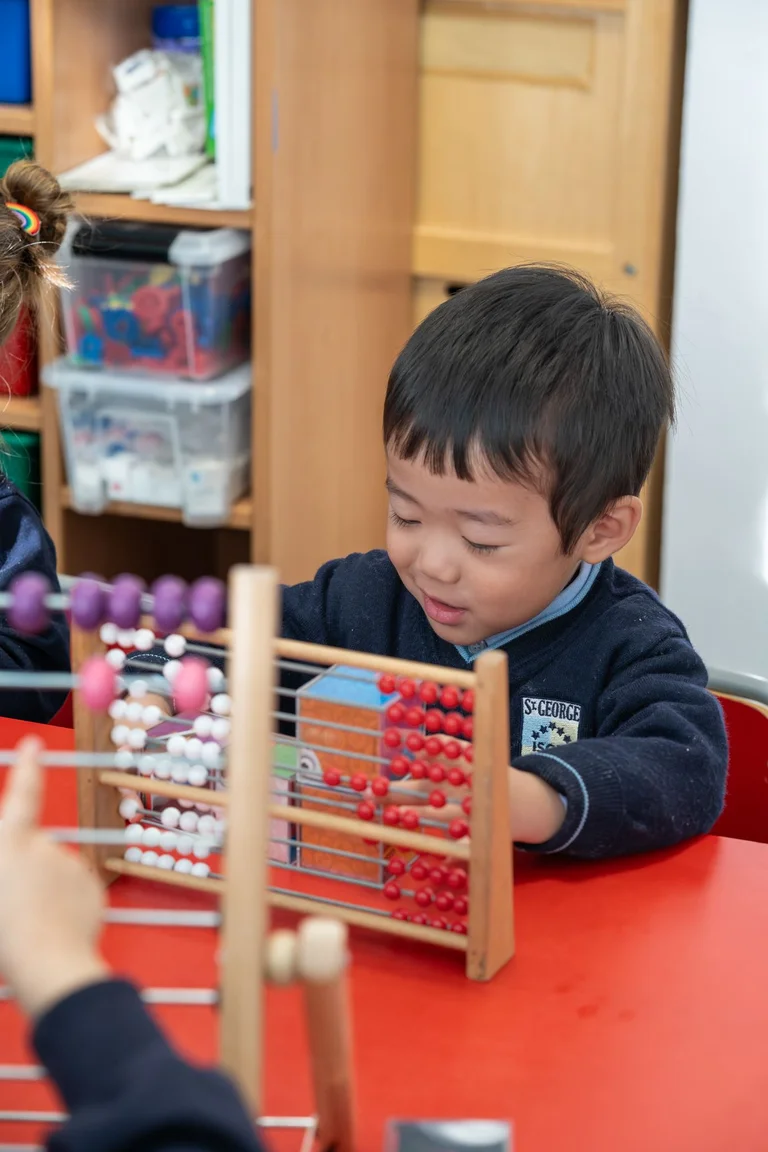 child plays with abacus