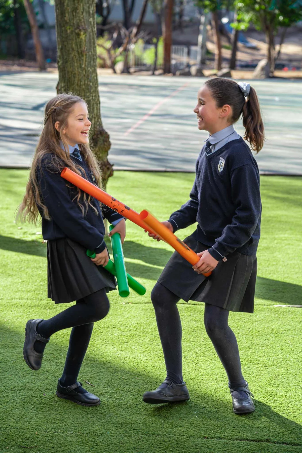Two students playing with tubes