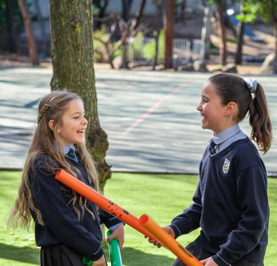 Two students playing with tubes
