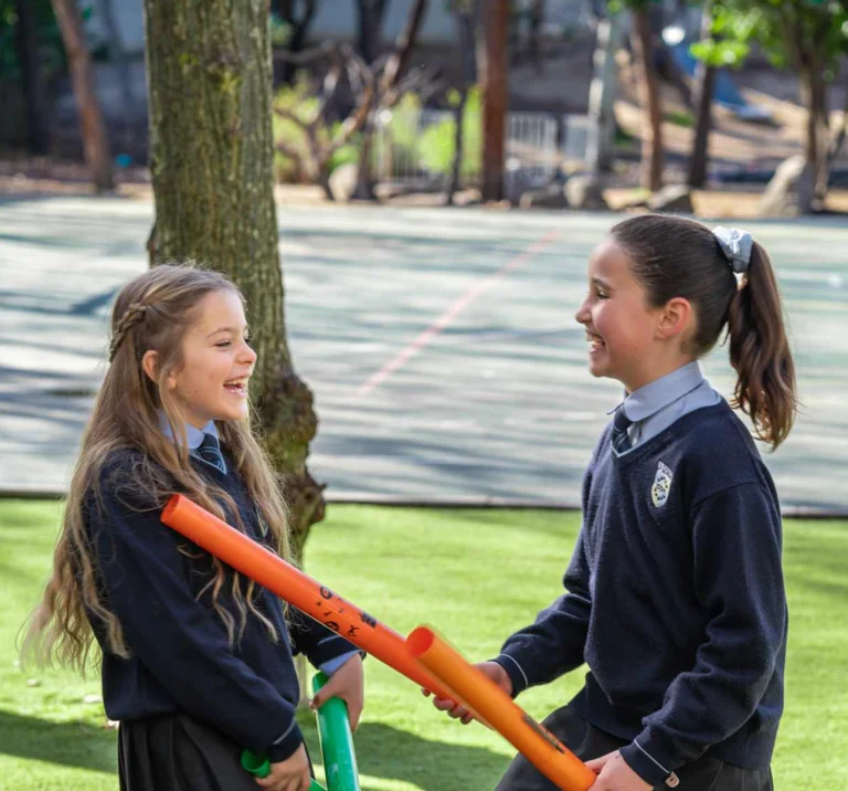 Two students playing with tubes