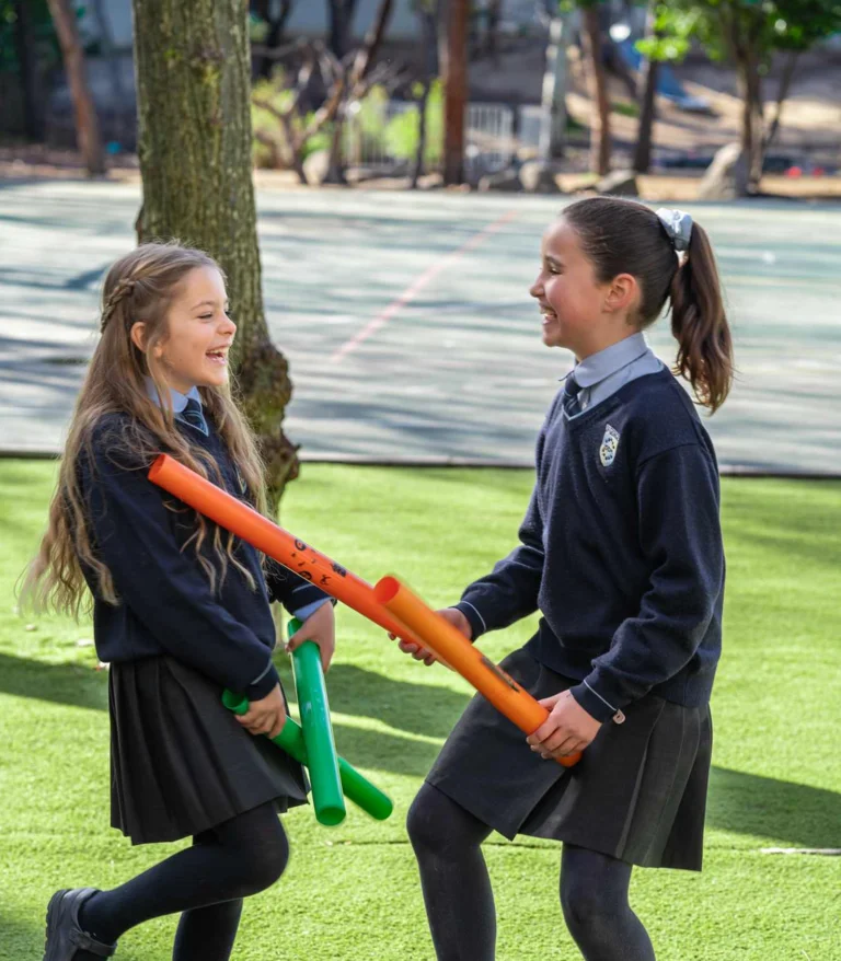 Two students playing with tubes