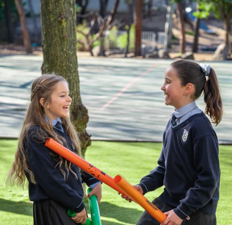 Two students playing with tubes