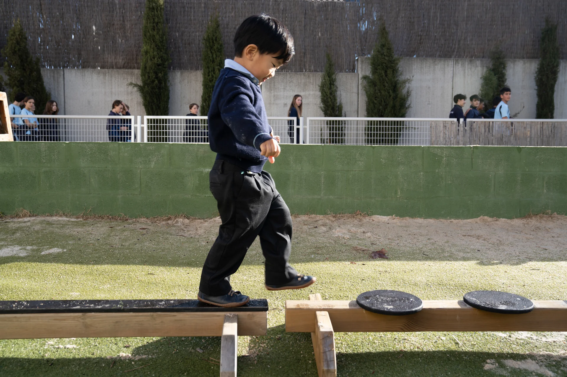 Child balancing on a wood 
