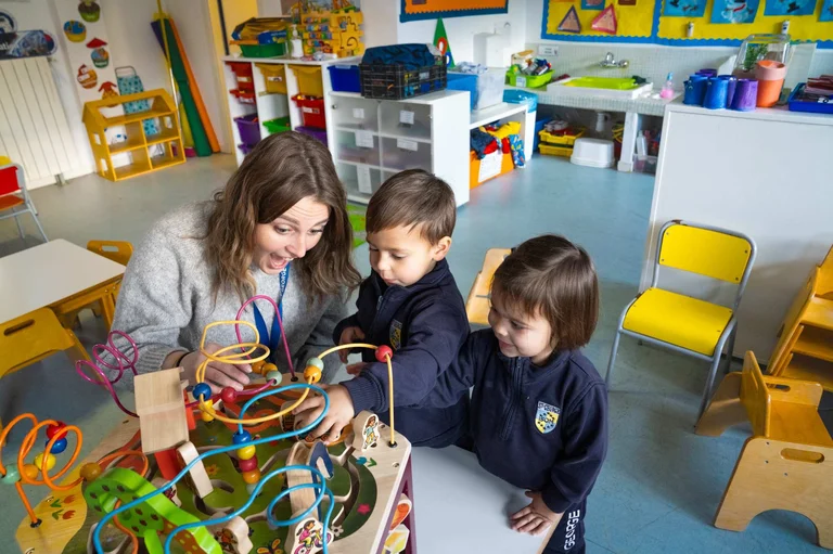 Teacher and students playing in the classroom