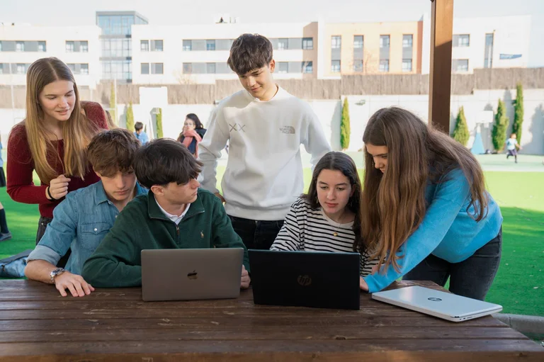 Students looking at the computers