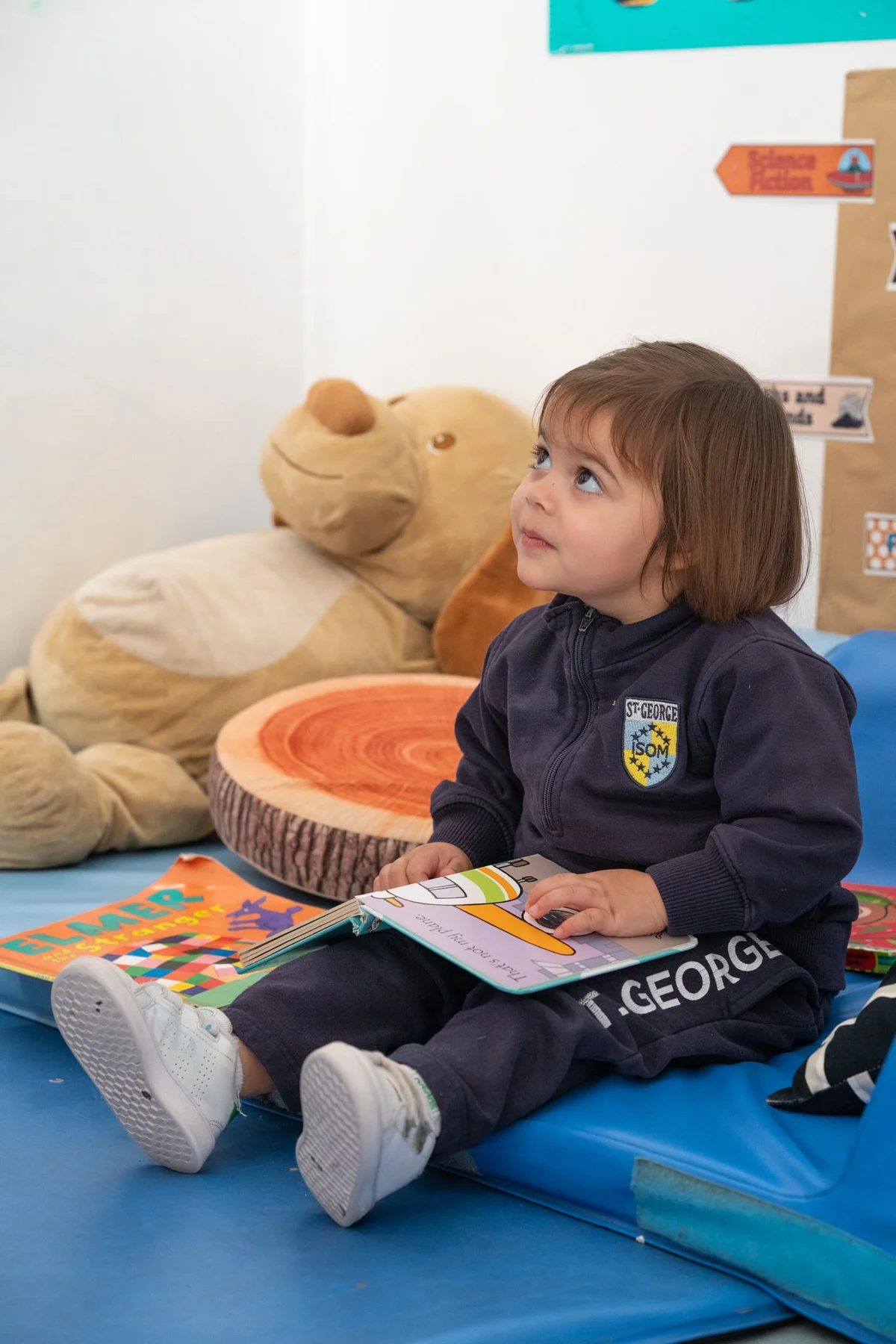 Kid in uniform with a book