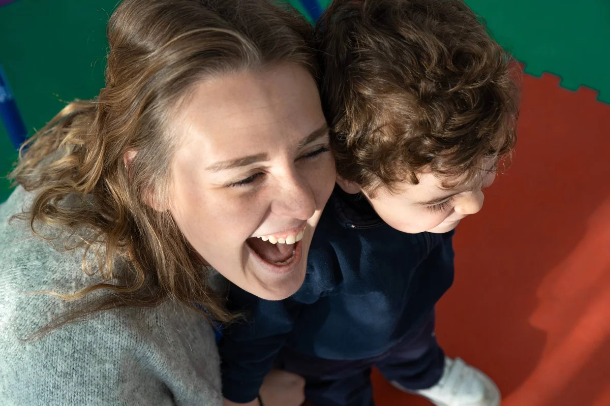 Teacher and kid smiling together