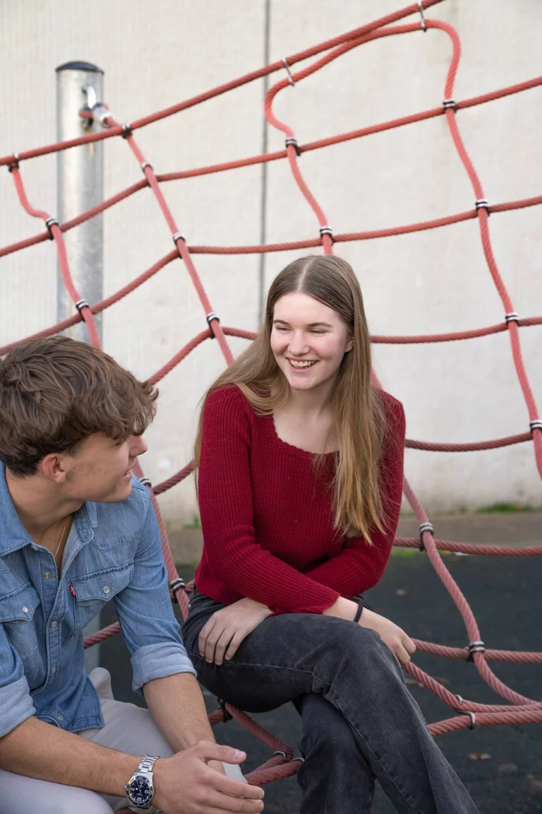 Two students smiling each other