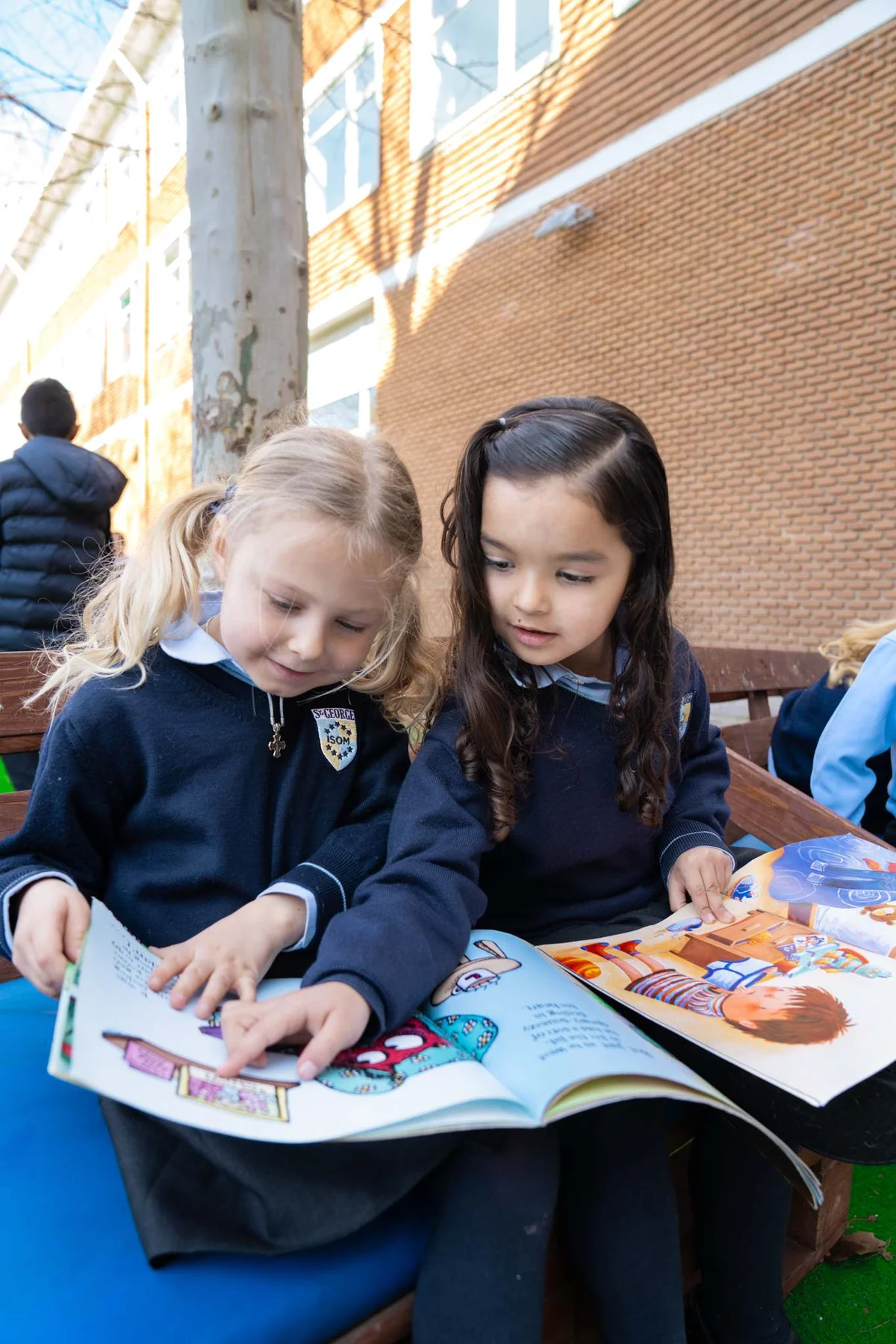 Two students looking at a book 