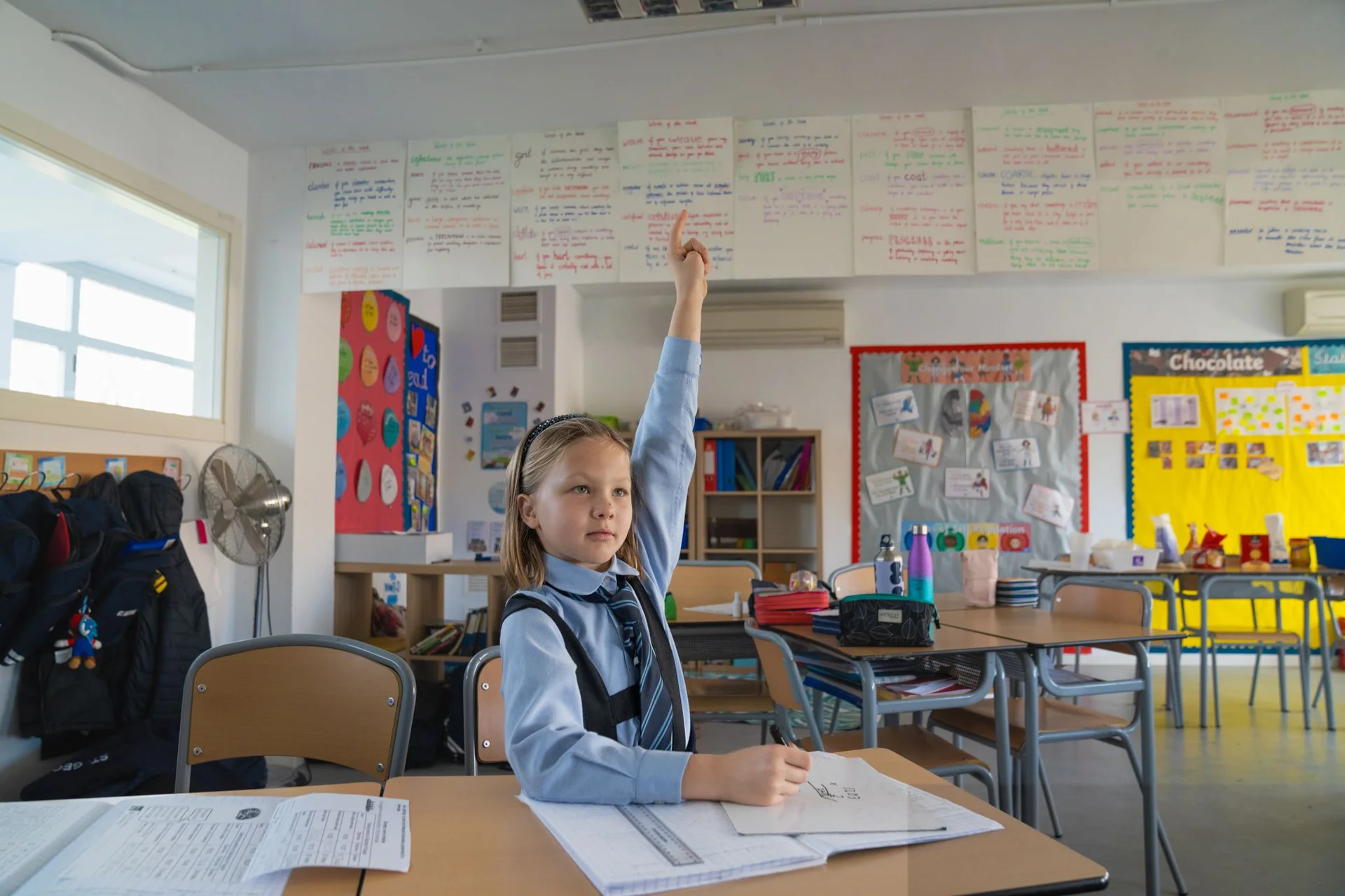 student with raised hand