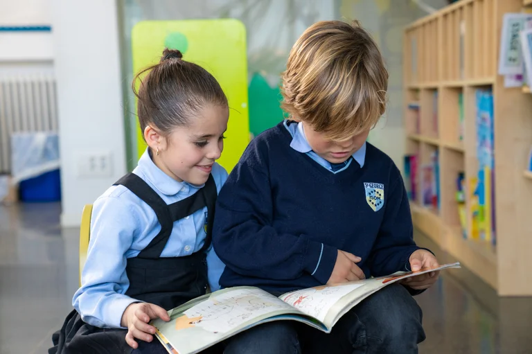 Two students reading a book
